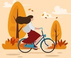 A Woman Riding Bike in Autumn Scenery