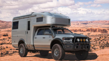 a truck driving down a dirt road