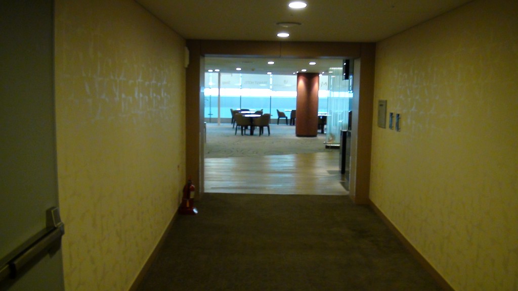 a hallway with a table and chairs