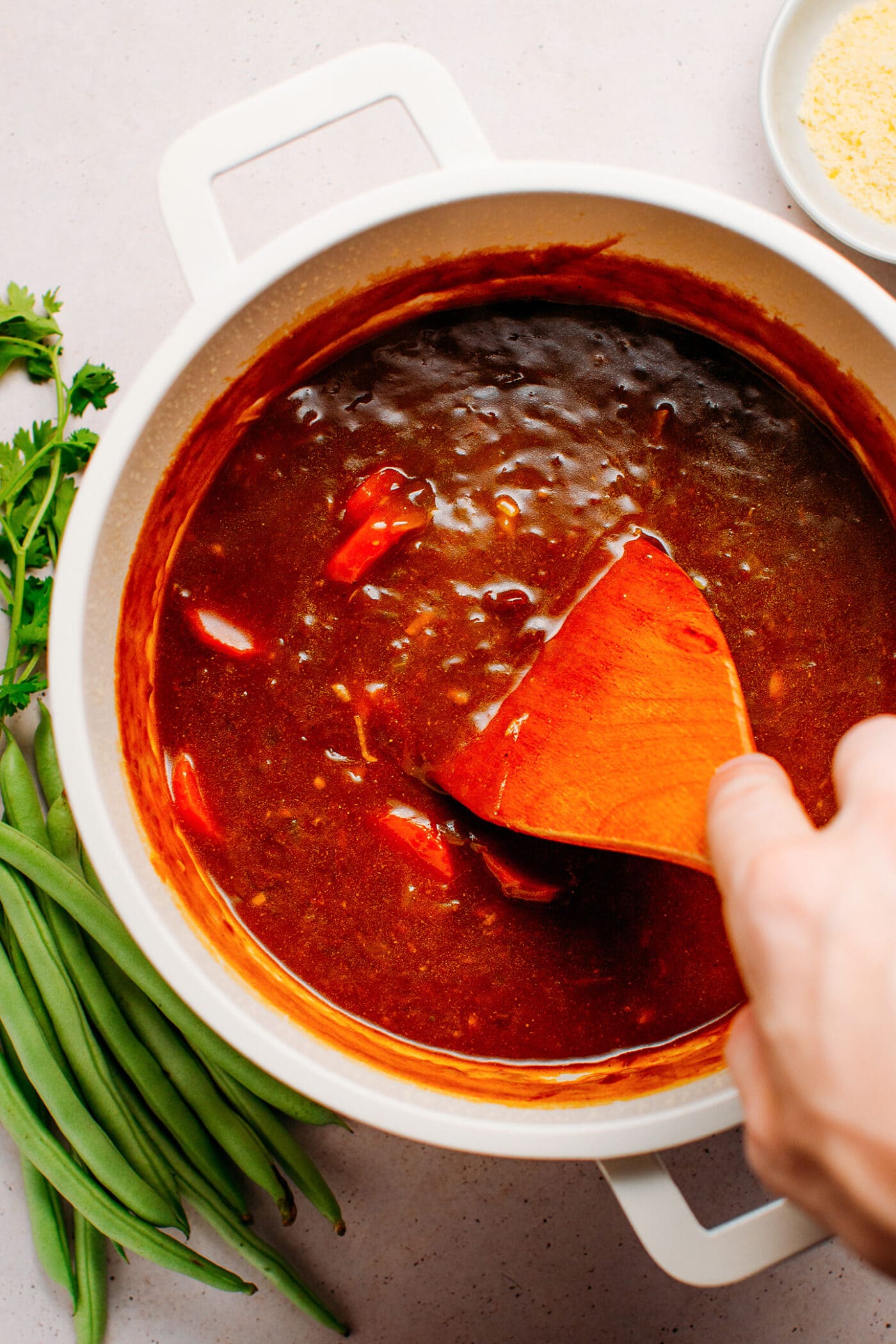 Stirring curry sauce in a pot.