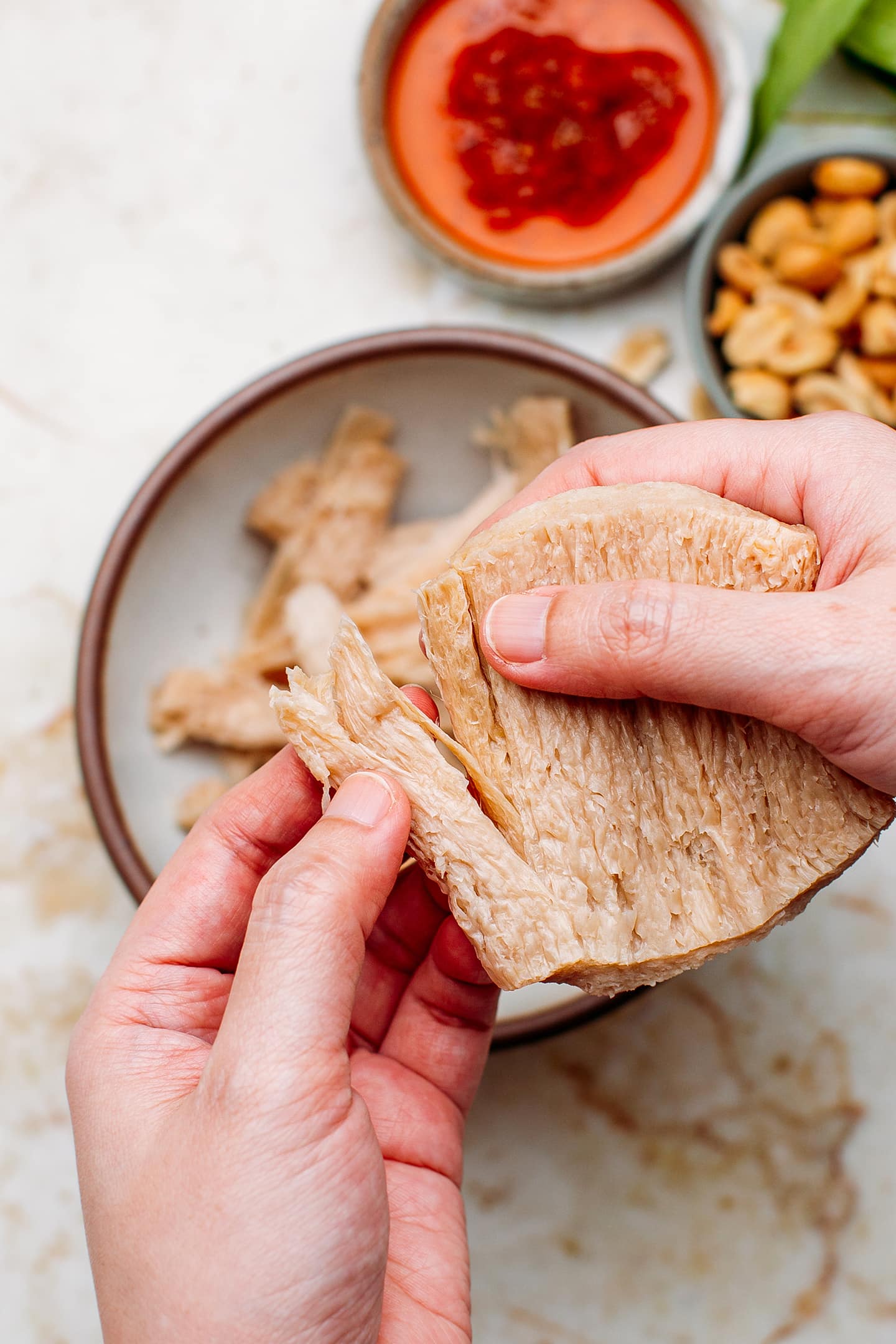 Shredding a slice of textured vegetable protein.