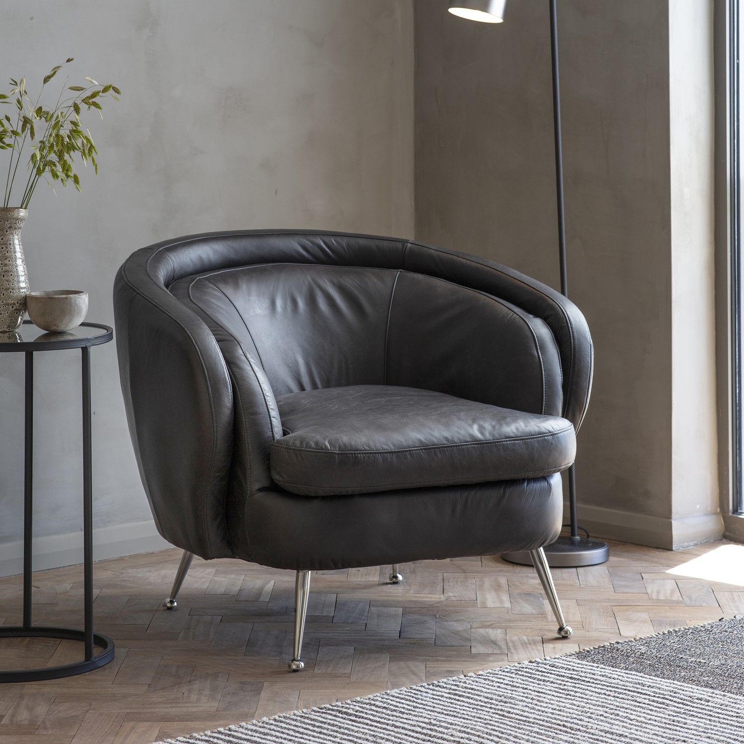 tub chair in black leather with metal legs  caspian house