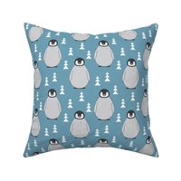 large penguins with triangle trees on blue