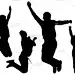 Silhouettes of young happy boys who jump in height