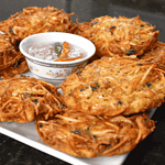 Okoy, also known as shrimp fritters, is a popular Filipino snack or appetizer made with small shrimp and vegetables mixed in a batter and then deep-fried. It is usually served with soy sauce or vinegar for dipping.