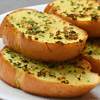 Garlic bread is a popular side dish made from sliced bread, typically baguette or Italian loaf, that has been seasoned with garlic and butter before being baked or grilled. It is a staple in Italian cuisine but has now become a beloved addition to meals all over the world.