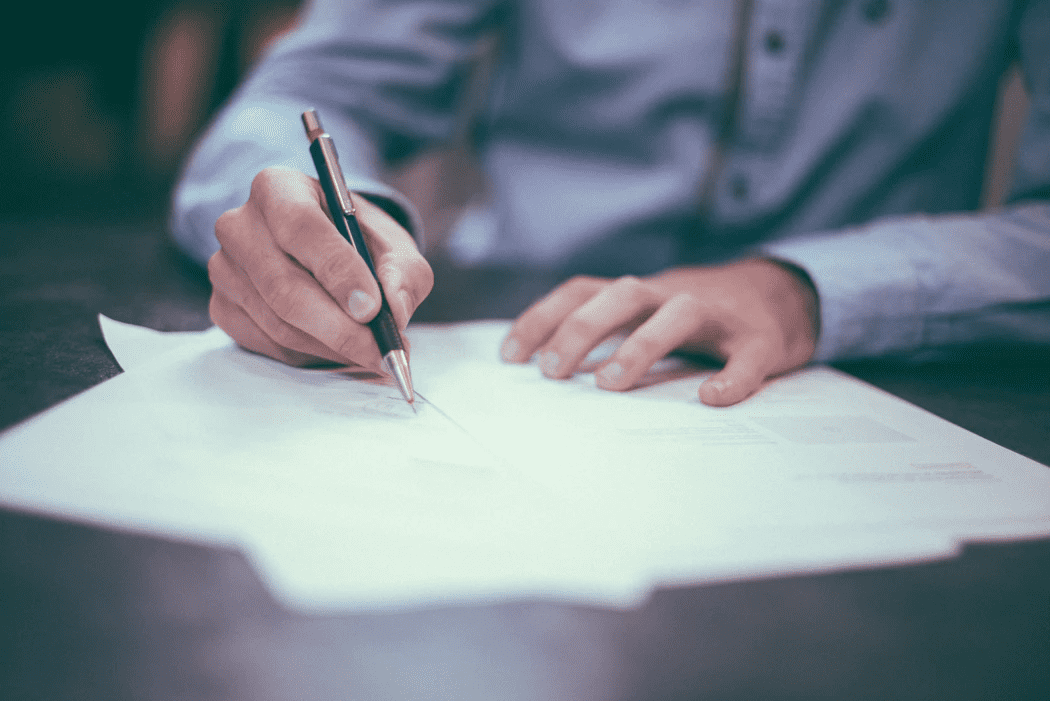 manager writing up an employee on paper