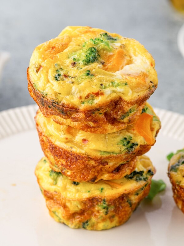 Three egg muffins stacked on a plate.