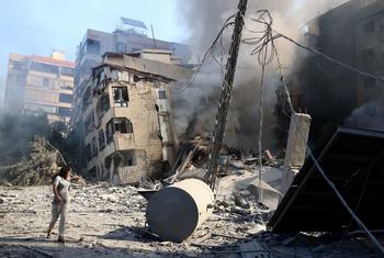 A woman walks past a destroyed building in the southern suburbs of Beirut, the Lebanese capital.