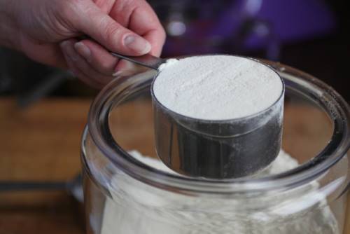 Measuring flour for gluten-free sandwich bread.