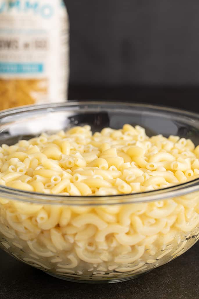 Glass bowl with cooked gluten free elbow macaroni for gluten free mac and cheese