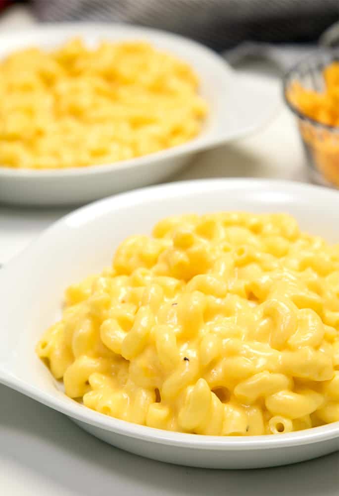 gluten free mac and cheese in white dish on white cloth