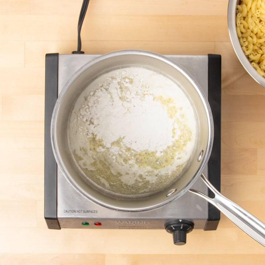 round metal saucepan with melted butter and unmixed white flour