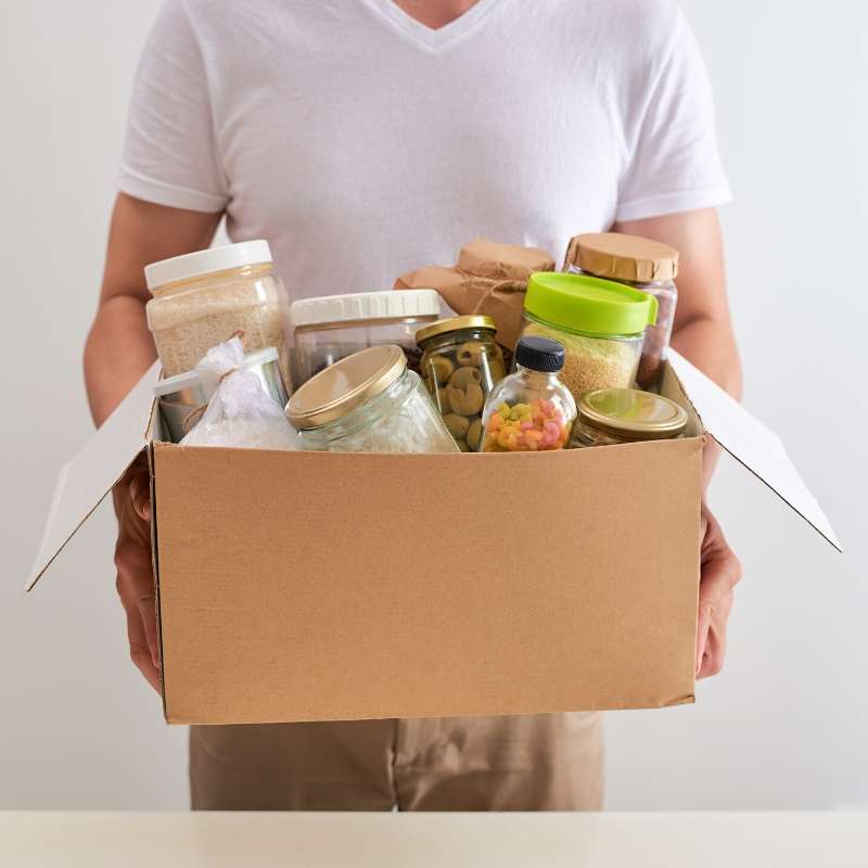 man bringing food in box to alleviate food insecurity