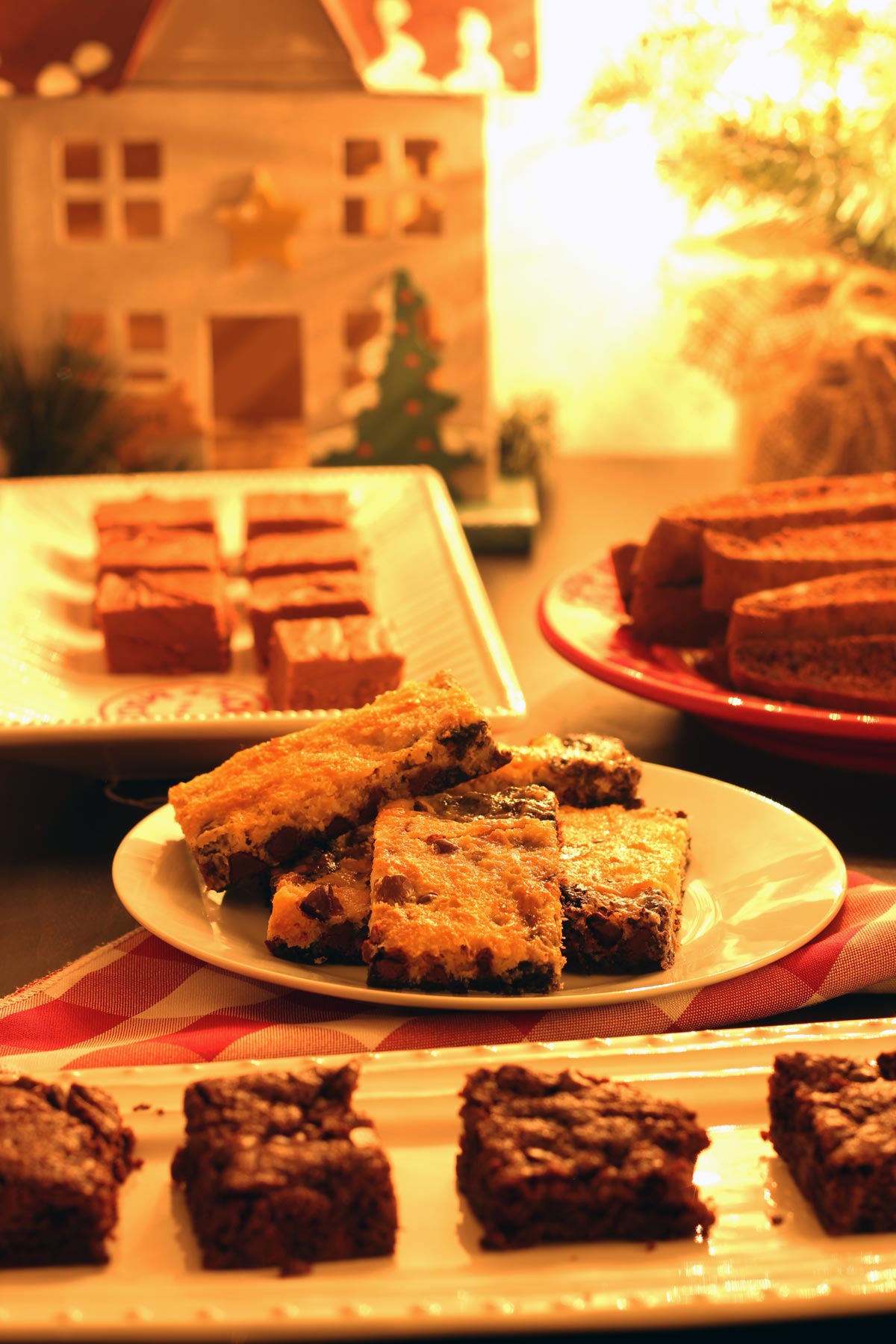 dessert table laid with many trays of different Christmas cookies.