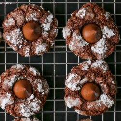 close up of four chocolate mint cookies on cooling rack.