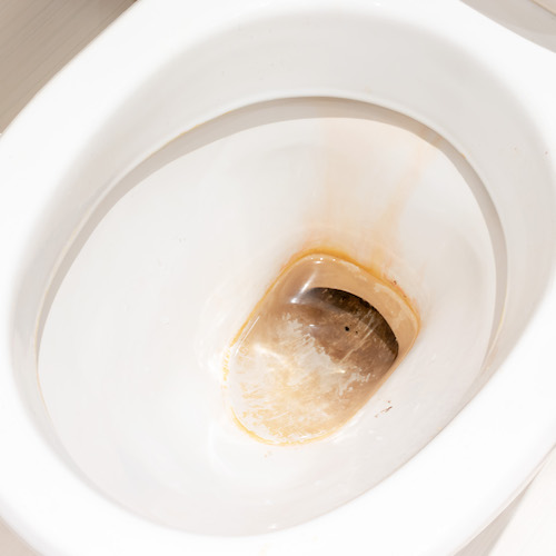 Dirty toilet bowl with limescale