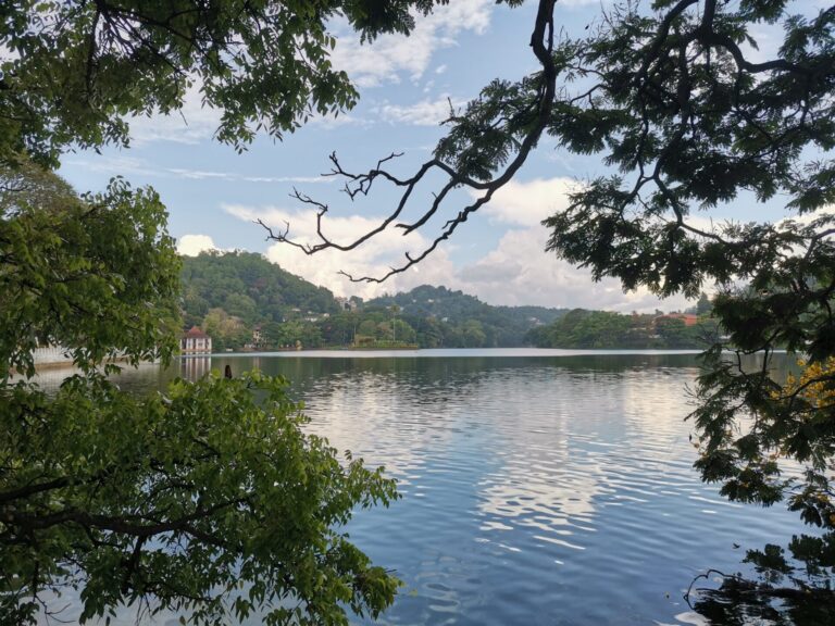 A still Kandy Lake on a partly cloudy day in Kandy, Sri Lanka