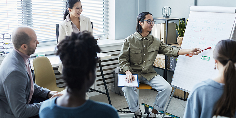 young asian man teaching a class on language