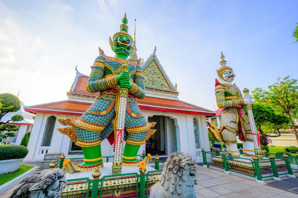 Giant at the entrance of Wat Arun Ratchawararam temple in Bangkok