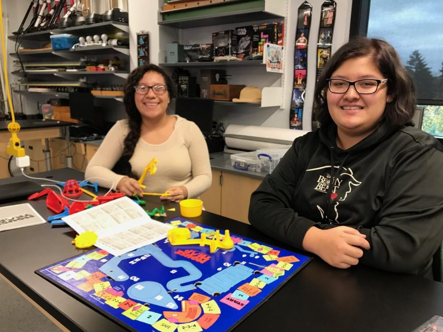 Alexandra Perez and Eowyn Keaton assemble their game board.