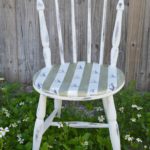 DIY nautical accent chair makeover. Furniture painting tutorial for stripes and sailboat stenciling with resource list. Make your own coastal accent chair. Find more home decor tutorials at H2OBungalow.com