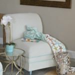 DIY painted upholstered chair makeover tutorial. How to paint a fabric chair with latex paint, add new trim and change the furniture legs for an easy update. Find over 450 home decor DIY tutorials on H2OBungalow.com