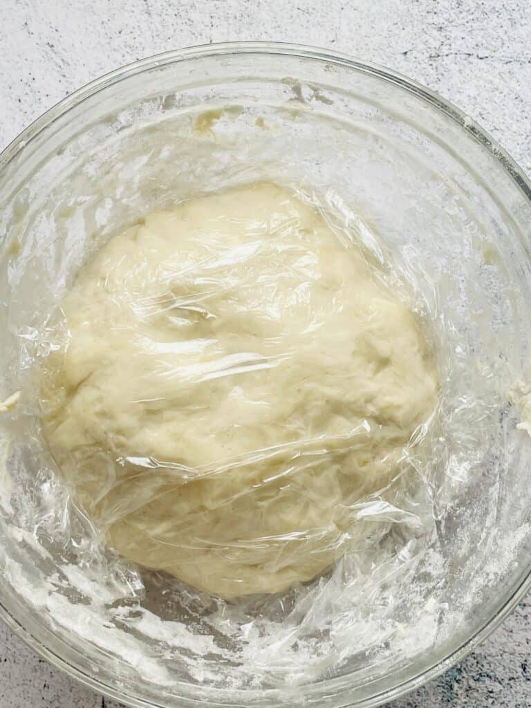 Roti dough covered in cling film