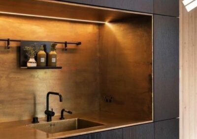 copper splashback in alcove surrounding kitchen sink