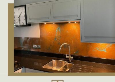 copper backsplash with blue patina above kitchen sink