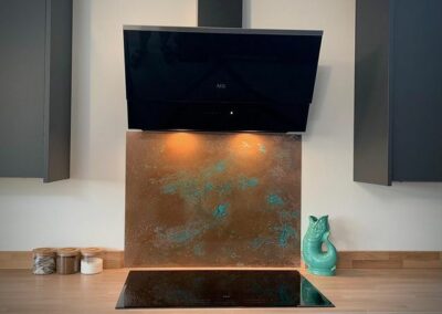 aged copper backsplash in grey kitchen