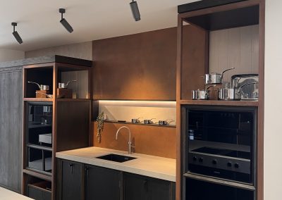 copper splashback behind kitchen sink and matching wall panel above