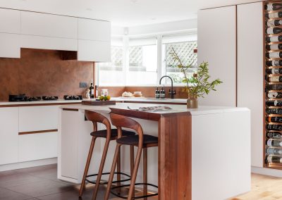 aged copper splashback in white modern kitchen