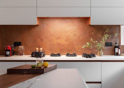 copper splashback with cutouts for plug sockets