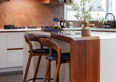 custom wooden kitchen island and matching aged copper wall panels