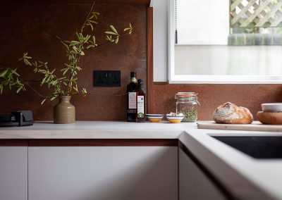 aged copper wall panels in white modern kitchen