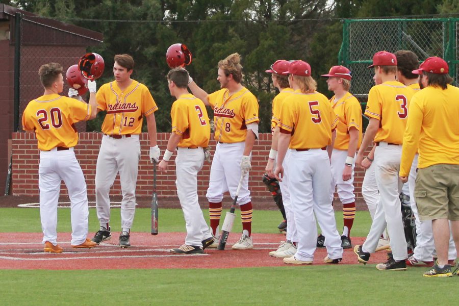 After hitting a home run at the April 9 baseball game against Great Bend, senior Cody Peterson celebrates with his team at home plate. This was the first score of the game. “Hitting a home run no matter what the circumstances is super cool,” Peterson said. “What makes it extra special, though, is knowing that you’ll always be greeted by the whole team cheering for you when you make it to home plate.”