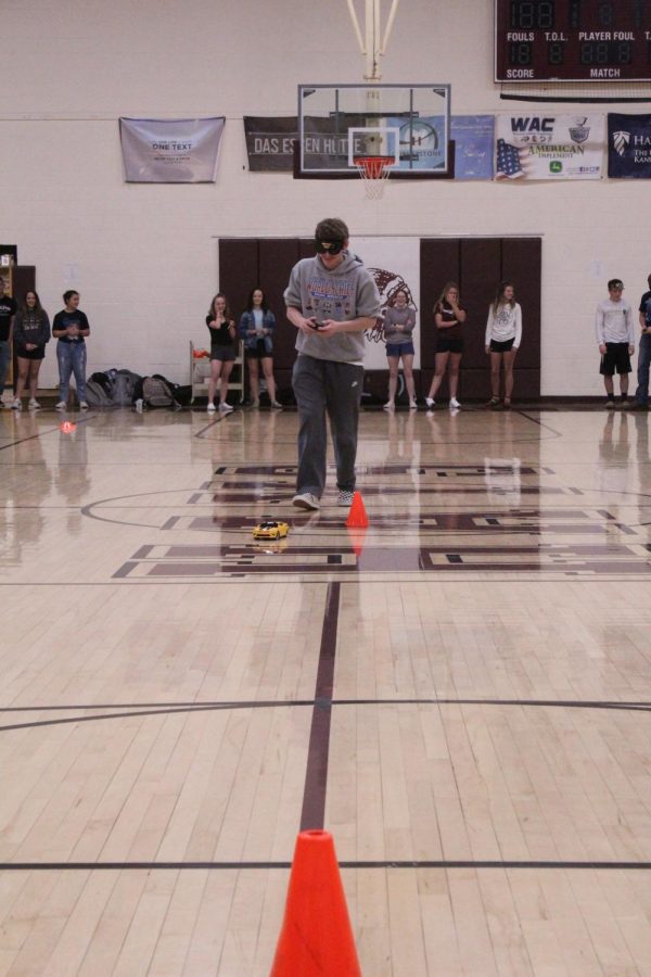 Junior Coby Braun attempts to drive a race car in and out of cones while wearing vision impairing goggles.