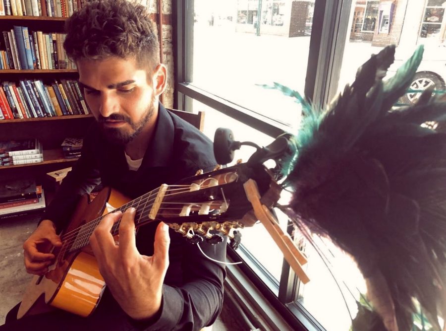 Artist, writer and classical guitarist Joshua Merello performs in "The Dusty Bookshelf" book store in Manhattan, Kan. Merello, who had played guitar as a hobby in and out of different bands, began taking music seriously at the beginning of 2018 when his father was diagnosed with terminal cancer. The family struggled to express their emotions in words, but through playing guitar for his parents during that time, Merello found he was able to pour both his joys and struggles into his music.