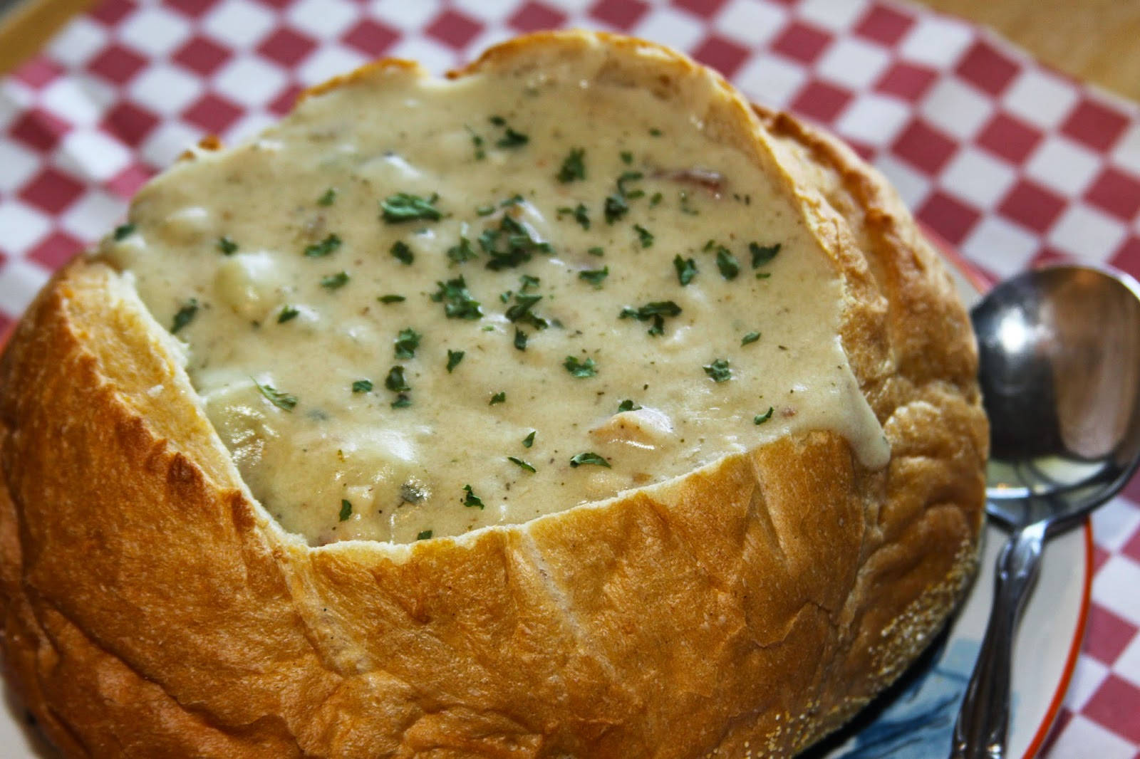 Enjoying New England Clam Chowder Served In A Bread Bowl. Wallpaper