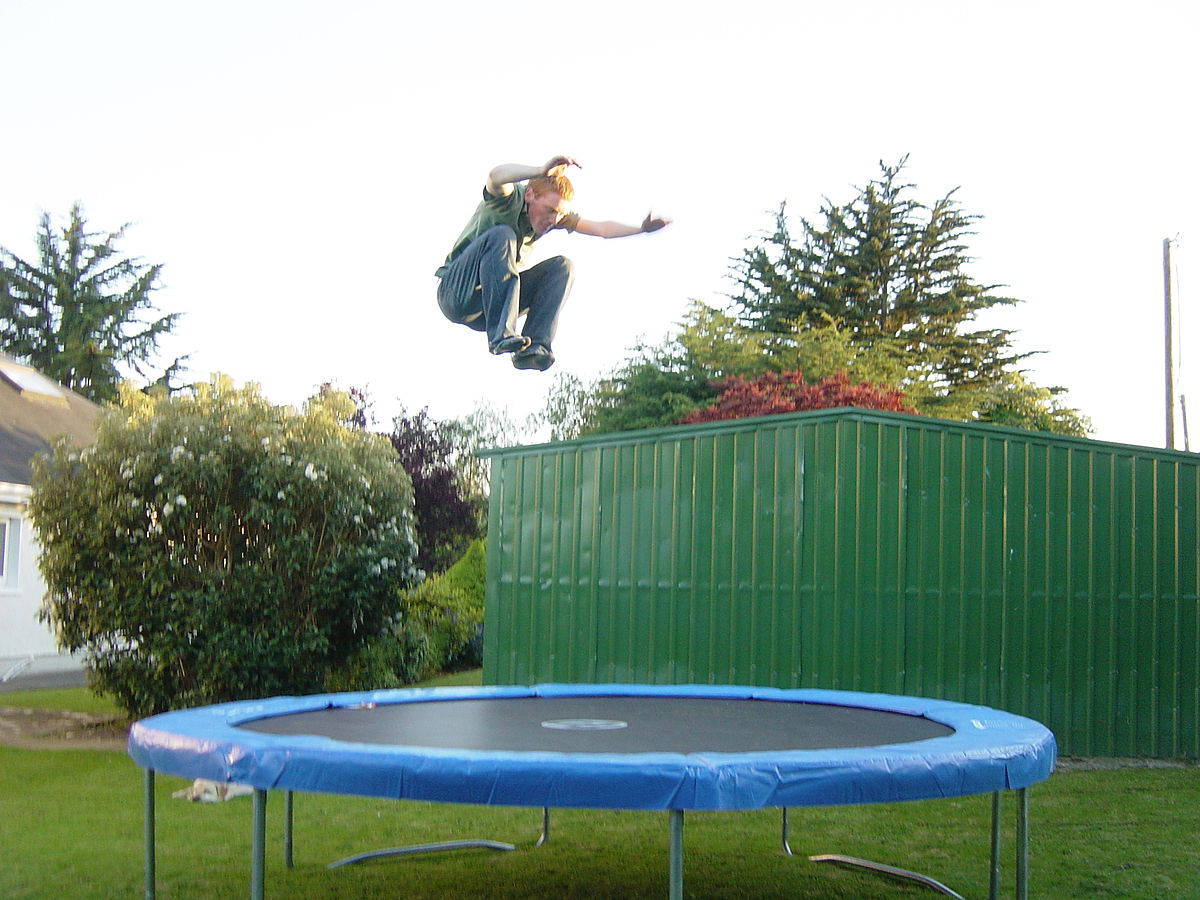 Man Jumping High From A Trampoline Wallpaper