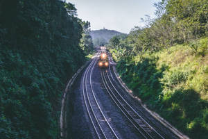 A Scenic Train Ride In The Mountains Wallpaper