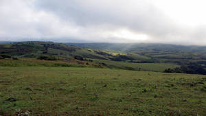 A Stunning Panorama Of Green Fields In Burundi Wallpaper