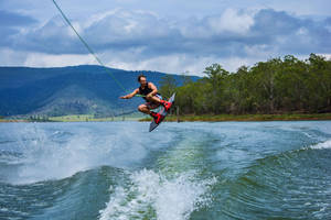 Caption: Aerial Mastery In Wakeboarding Wallpaper