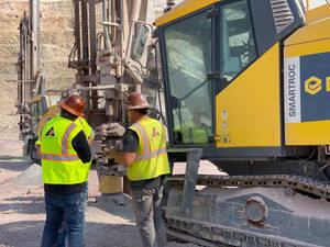 Caption: An Operator Manning A Blast-hole Drill On A Construction Site. Wallpaper