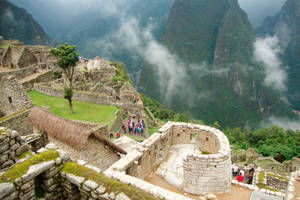 Caption: Captivating Sunrise Over The Temple Of The Sun In Machu Picchu Wallpaper