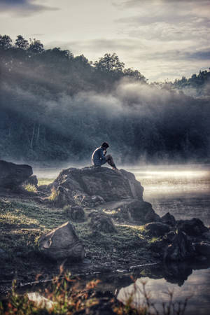 Man With Phone Sitting Alone Wallpaper