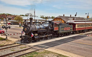 Passengers Taking A Vintage Steam Locomotive Train Ride Wallpaper