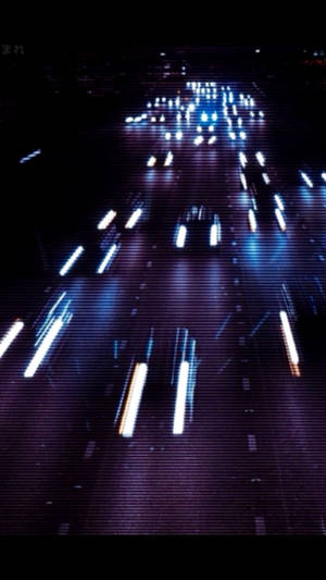 Streetlights And Traffic Illuminate The Night In A Grungy Neighborhood. Wallpaper