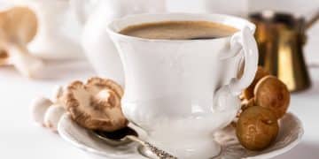 A white cup with steaming-hot mushroom coffee